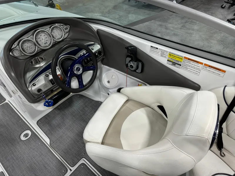 Slide: The Image of Steering console of a 2008 Azure 278 boat with white seating and gauges. - 11