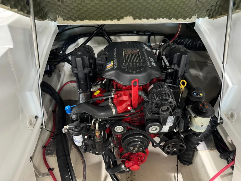 Slide: The Image of 2008 Azure 278 boat engine compartment with red and black motor components. - 14