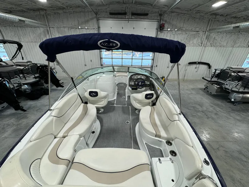 Slide: The Image of 2008 Azure 278 boat interior with seating and canopy in a garage setting. - 6