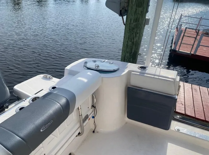 Slide: The Image of 2021 Robalo R272 Center Console boat interior by the water. - 14