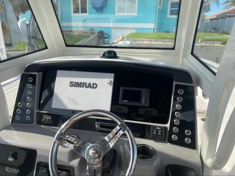 Slide: The Image of 2021 Robalo R272 Center Console dashboard with Simrad navigation system. - 3