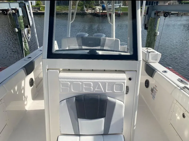 Slide: The Image of 2021 Robalo R272 Center Console boat interior with seating and console view. - 8