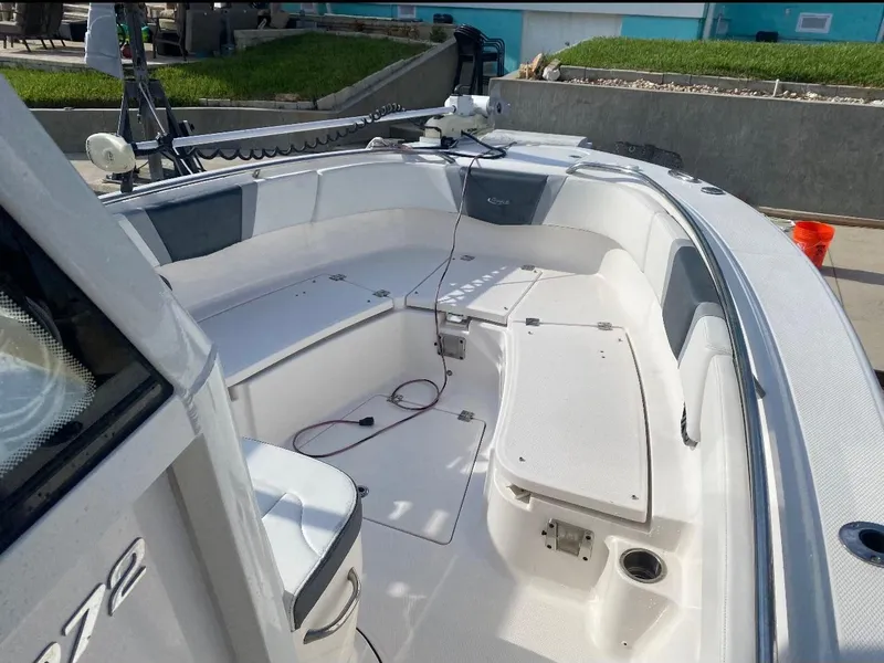 Slide: The Image of 2021 Robalo R272 Center Console boat interior with seating and storage. - 9