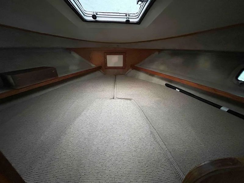 Slide: The Image of Interior cabin of 1986 Silverton 31 Convertible boat with carpeted flooring. - 16