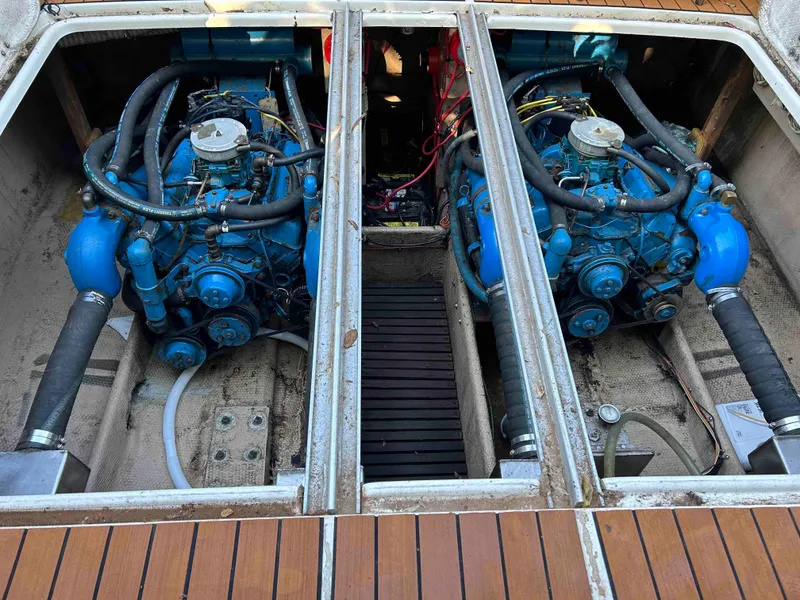 Slide: The Image of 1986 Silverton 31 Convertible boat engine compartment with dual blue engines. - 20