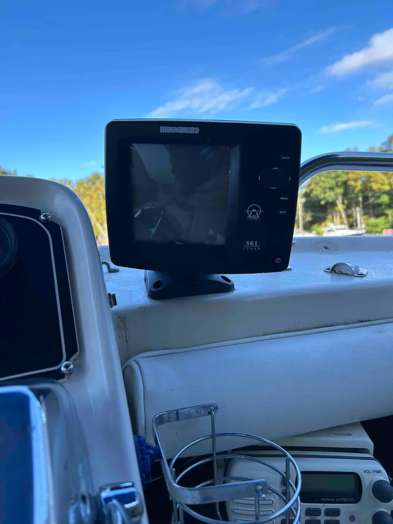 Slide: The Image of 1986 Silverton 31 Convertible boat dashboard with navigation equipment and clear blue sky. - 6