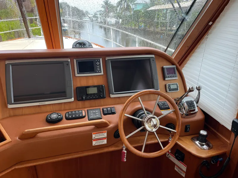 Slide: The Image of 2013 Sabre 48 Salon Express helm with dual screens and wooden steering wheel. - 11