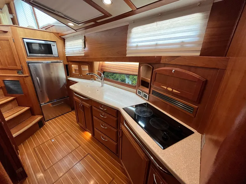 Slide: The Image of Luxurious 2013 Sabre 48 Salon Express yacht kitchen with wood cabinetry and modern appliances. - 13