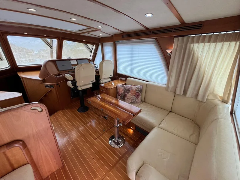 Slide: The Image of Interior of 2013 Sabre 48 Salon Express with plush seating and wooden accents. - 15