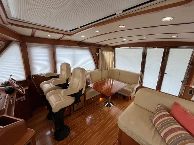 Slide: The Image of Interior of 2013 Sabre 48 Salon Express yacht with plush seating and wooden accents. - 20