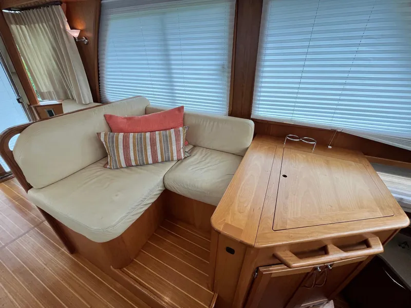 Slide: The Image of Interior of 2013 Sabre 48 Salon Express with cozy seating and wooden table. - 27