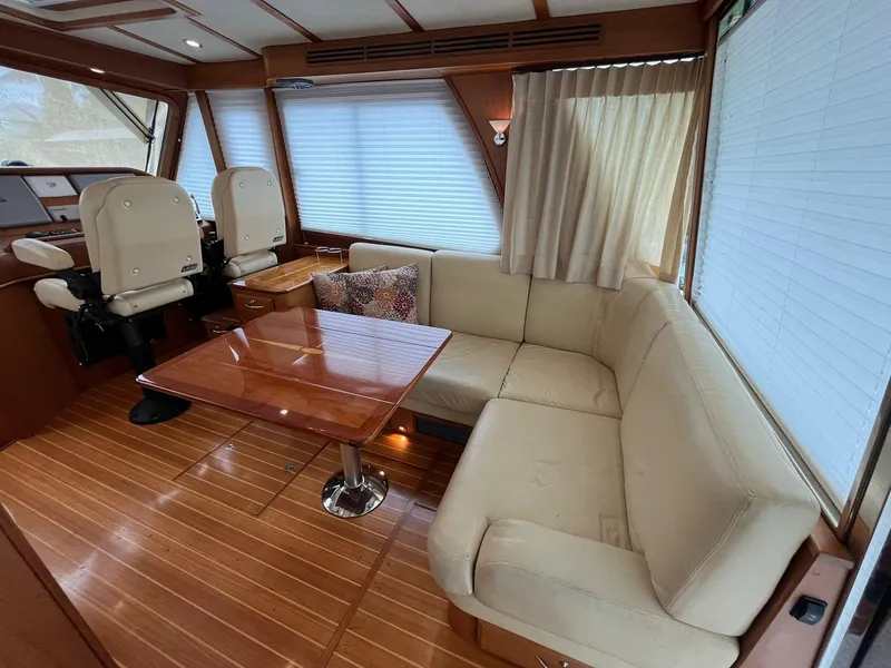 Slide: The Image of Interior of 2013 Sabre 48 Salon Express with beige seating and wooden table. - 29