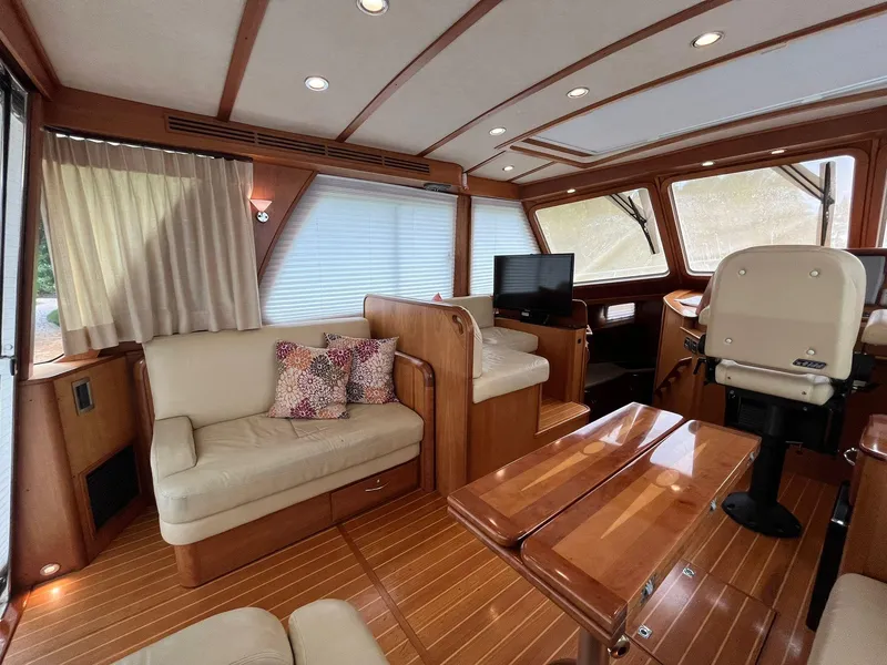 Slide: The Image of 2013 Sabre 48 Salon Express interior with elegant wood finish and comfortable seating. - 34