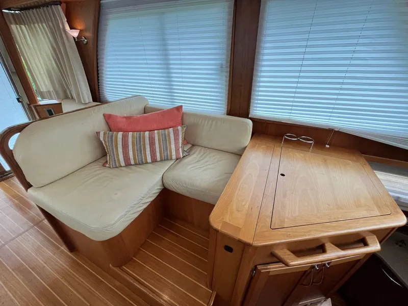 Slide: The Image of 2013 Sabre 48 Salon Express interior with cozy seating and wooden table. - 36