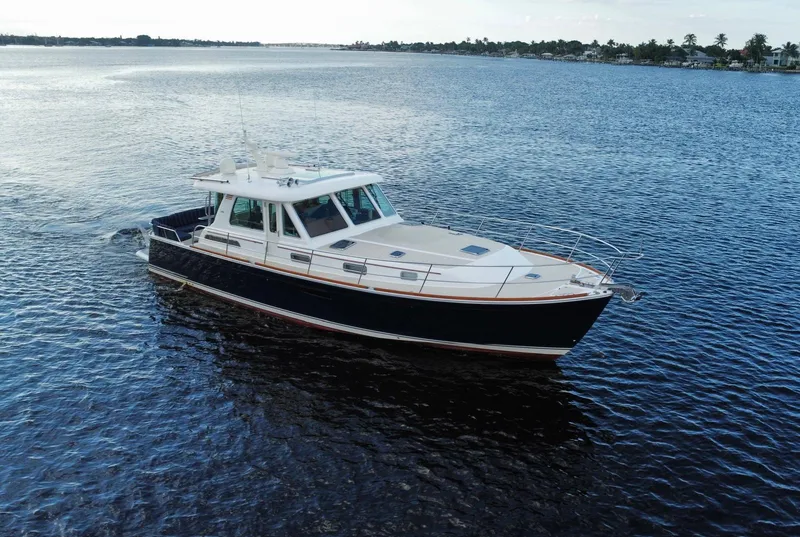 Slide: The Image of 2013 Sabre 48 Salon Express yacht cruising on open water. - 4