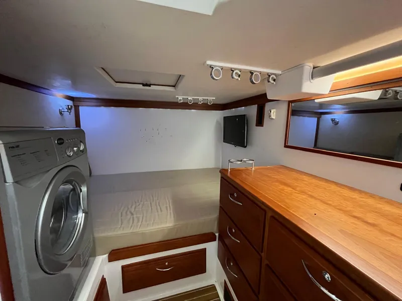 Slide: The Image of Interior of 2013 Sabre 48 Salon Express with bed, washer, and wooden cabinetry. - 41