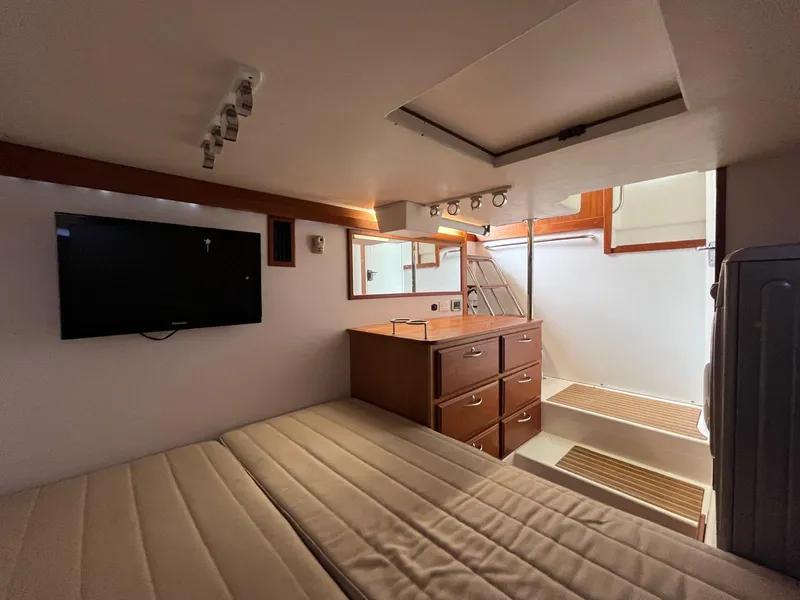Slide: The Image of Interior of 2013 Sabre 48 Salon Express with bed, TV, and stairs. - 42