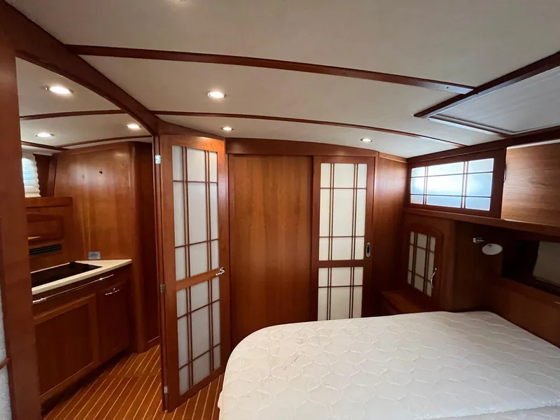 Slide: The Image of Luxurious 2013 Sabre 48 Salon Express interior with wood finish and cozy bedroom. - 46