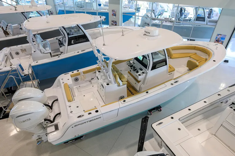 The Image of 2025 Sportsman Open 282 Center Console boat in showroom, featuring dual Yamaha engines. - 0