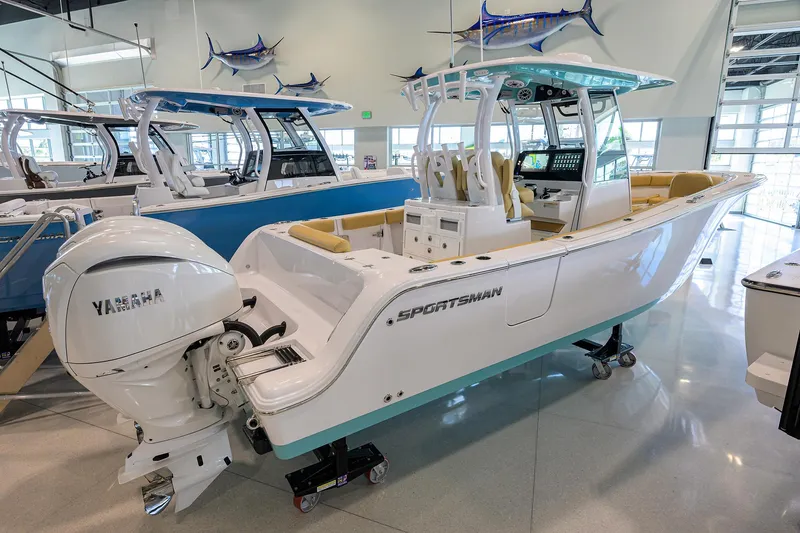 Slide: The Image of 2025 Sportsman Open 282 Center Console boat displayed indoors with Yamaha engine. - 1