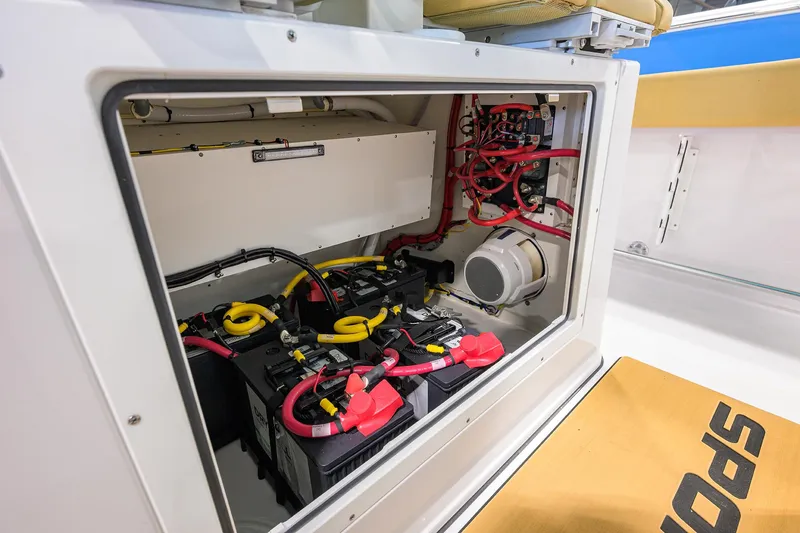 Slide: The Image of Electrical compartment of 2025 Sportsman Open 282 Center Console boat, showcasing battery setup. - 19