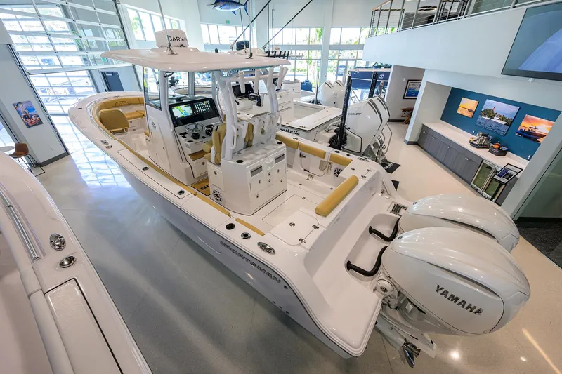 Slide: The Image of 2025 Sportsman Open 282 Center Console boat in showroom with Yamaha engines. - 2