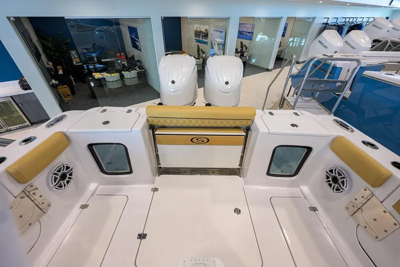 Slide: The Image of 2025 Sportsman Open 282 Center Console boat interior with dual engines in showroom. - 21