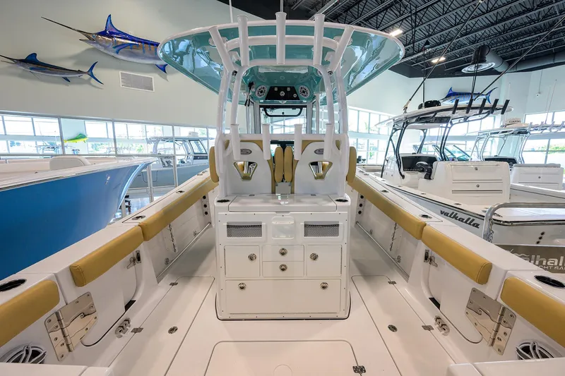 Slide: The Image of 2025 Sportsman Open 282 Center Console boat interior in showroom with mounted fish displays. - 25