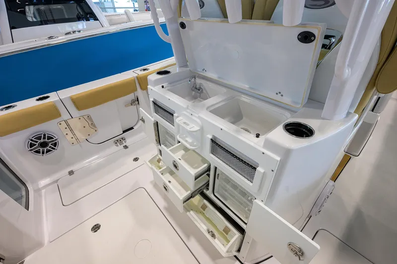 Slide: The Image of 2025 Sportsman Open 282 Center Console boat interior with storage compartments and sink. - 27