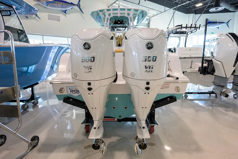 Slide: The Image of 2025 Sportsman Open 282 Center Console with dual Yamaha 300 V6 outboard engines in showroom. - 3