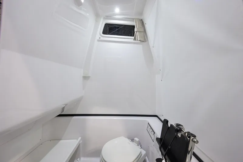Slide: The Image of 2025 Sportsman Open 282 Center Console interior with toilet and window. - 31