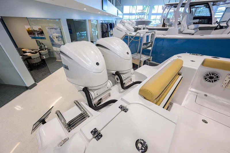 Slide: The Image of 2025 Sportsman Open 282 Center Console with dual Yamaha outboard engines in showroom. - 4