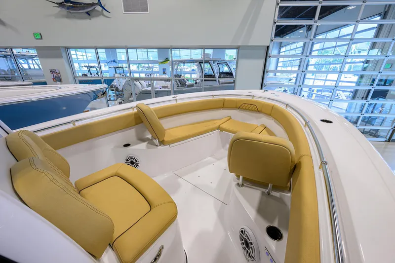 Slide: The Image of 2025 Sportsman Open 282 Center Console boat interior with tan seating in showroom. - 5