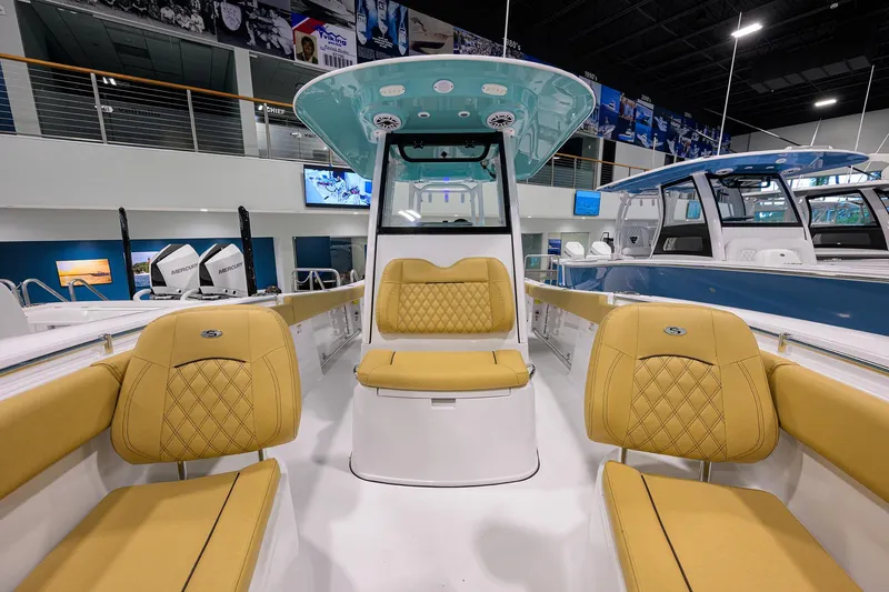 Slide: The Image of 2025 Sportsman Open 282 Center Console boat with tan seating in showroom. - 7