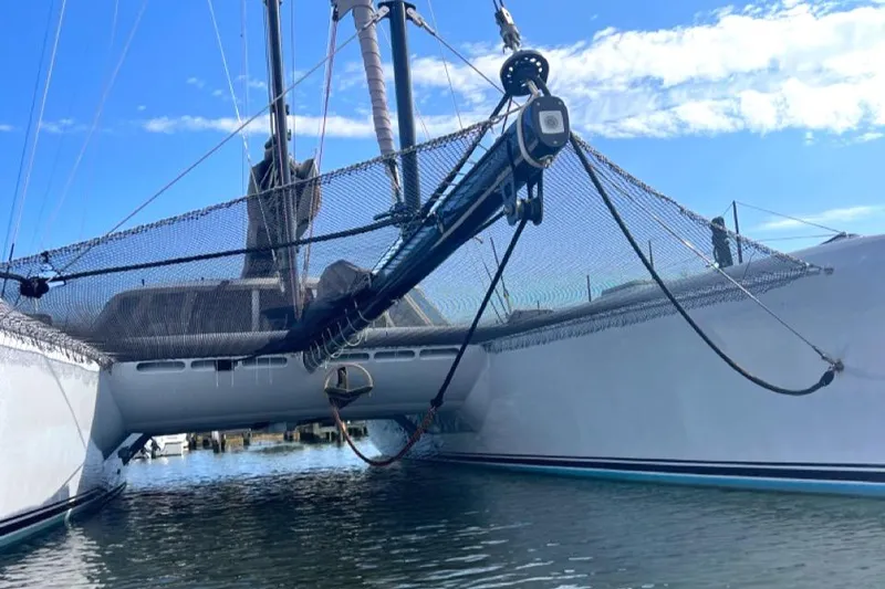 Slide: The Image of Morrelli & Melvin 2007 Shooting Star catamaran on water, featuring netting and sleek design. - 10