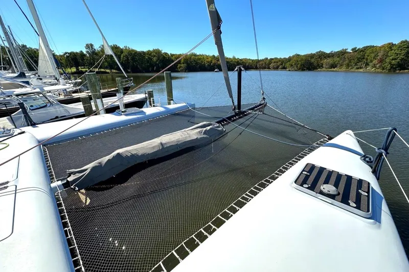 Slide: The Image of Morrelli & Melvin 2007 Shooting Star catamaran docked on a serene lake. - 18