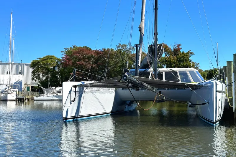 Slide: The Image of 2007 Morrelli & Melvin Shooting Star catamaran docked in a serene marina. - 6
