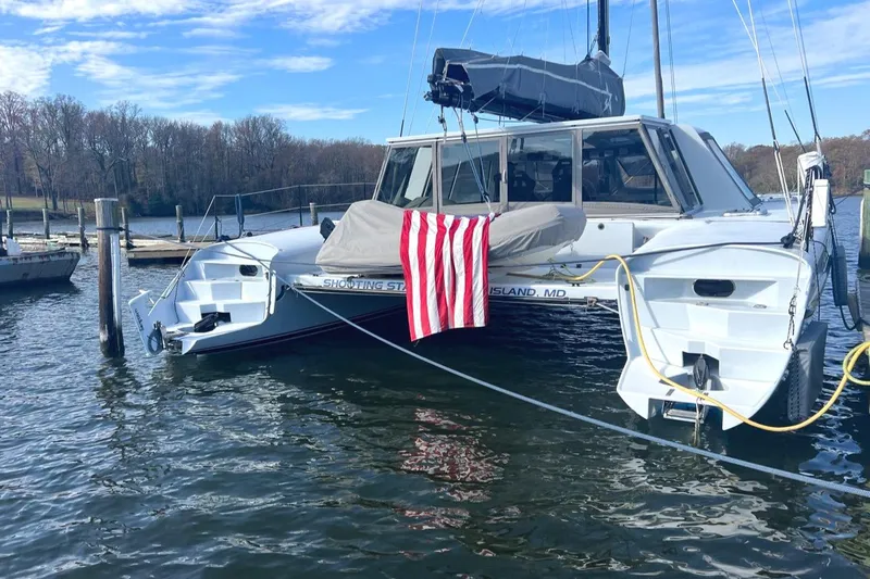Slide: The Image of Morrelli & Melvin 2007 Shooting Star catamaran docked with American flag. - 8