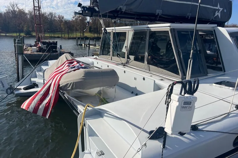 Slide: The Image of 2007 Morrelli & Melvin Shooting Star yacht docked with American flag draped over dinghy. - 9