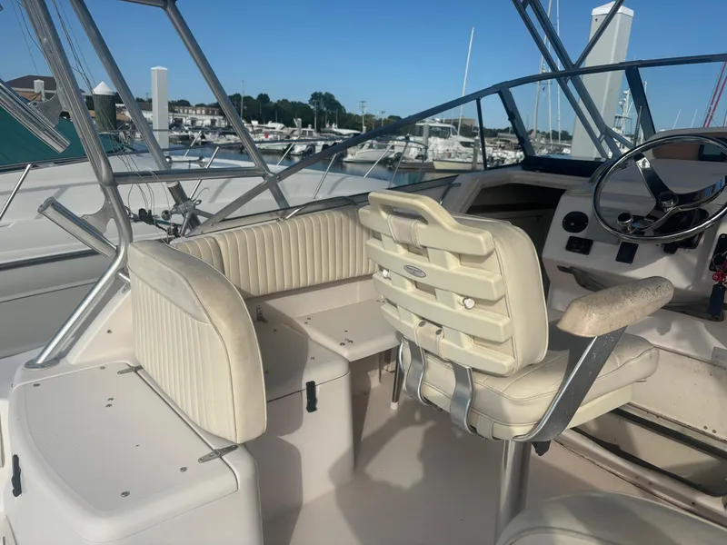 Slide: The Image of 2002 Grady-White 33 Express boat interior with helm and seating at marina. - 5