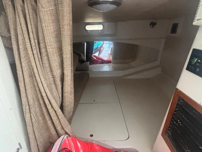 Slide: The Image of Interior cabin of 2002 Grady-White 33 Express boat with beige curtains and seating. - 9