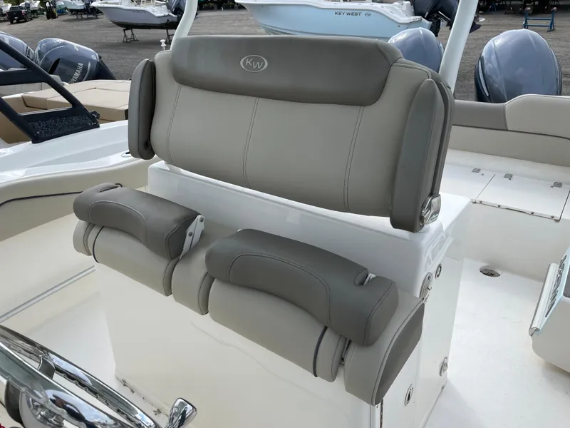 Slide: The Image of 2022 Key West 263 FS boat seating with gray upholstery and adjustable armrests. - 10