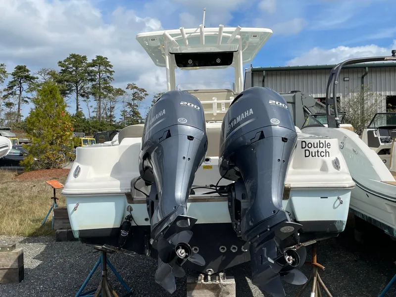 Slide: The Image of 2022 Key West 263 FS boat with twin Yamaha engines, named "Double Dutch," on display outdoors. - 3