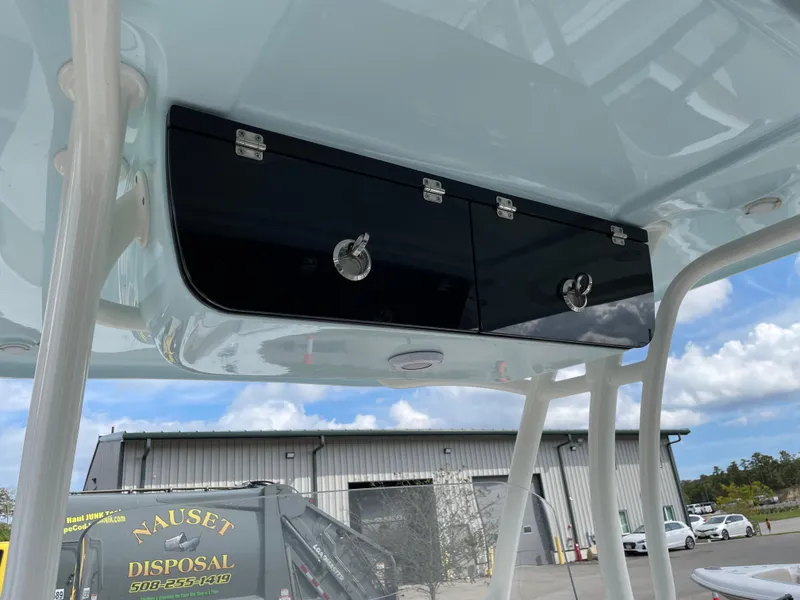 Slide: The Image of Key West 263 FS 2022 boat storage compartment under blue sky. - 9