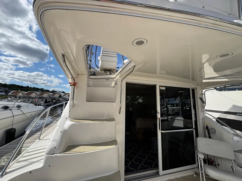 Slide: The Image of 1996 Sea Ray 400 Sedan Bridge yacht with stairs and sliding glass door. - 11
