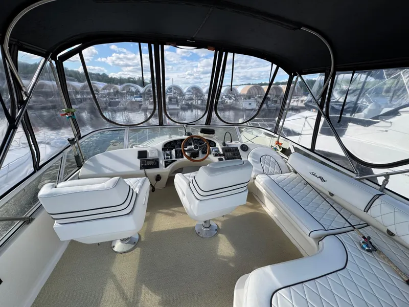 Slide: The Image of 1996 Sea Ray 400 Sedan Bridge interior with white seating and panoramic windows. - 13