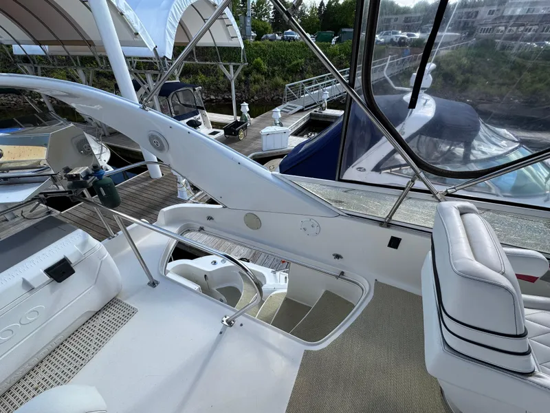 Slide: The Image of 1996 Sea Ray 400 Sedan Bridge yacht interior with white seating and helm station. - 14