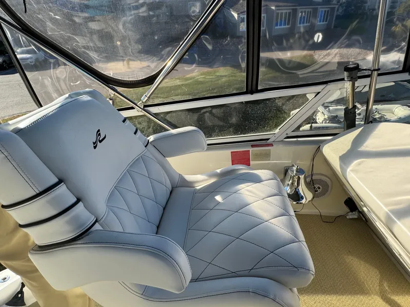 Slide: The Image of Captain's chair on 1996 Sea Ray 400 Sedan Bridge yacht, featuring luxurious white upholstery. - 15