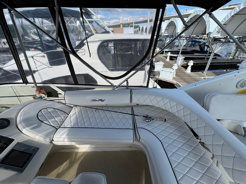 Slide: The Image of 1996 Sea Ray 400 Sedan Bridge interior with white leather seating at marina. - 22