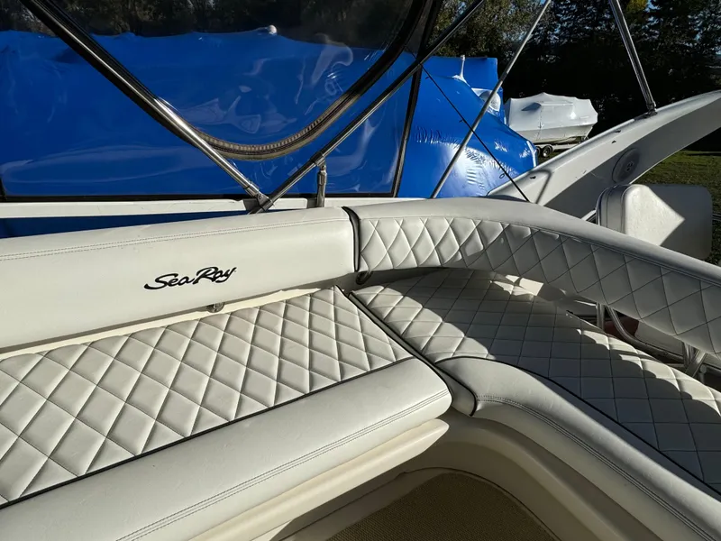 Slide: The Image of 1996 Sea Ray 400 Sedan Bridge with white quilted seating and blue cover. - 23